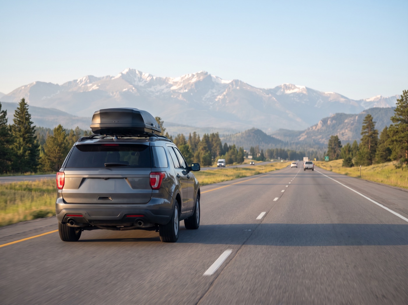 SUV with a roof box heading west on the Trans-Canada Highway toward the Rockies